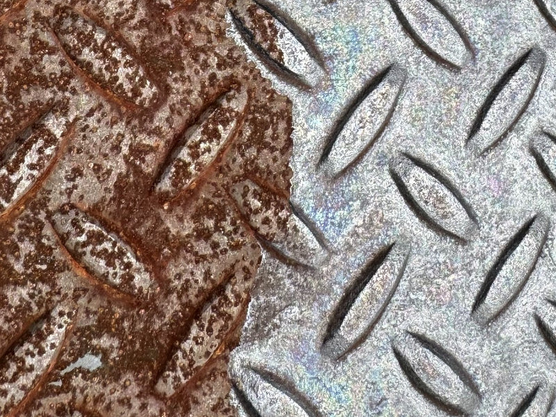 Rusty steel plate next to the treated, converted surface